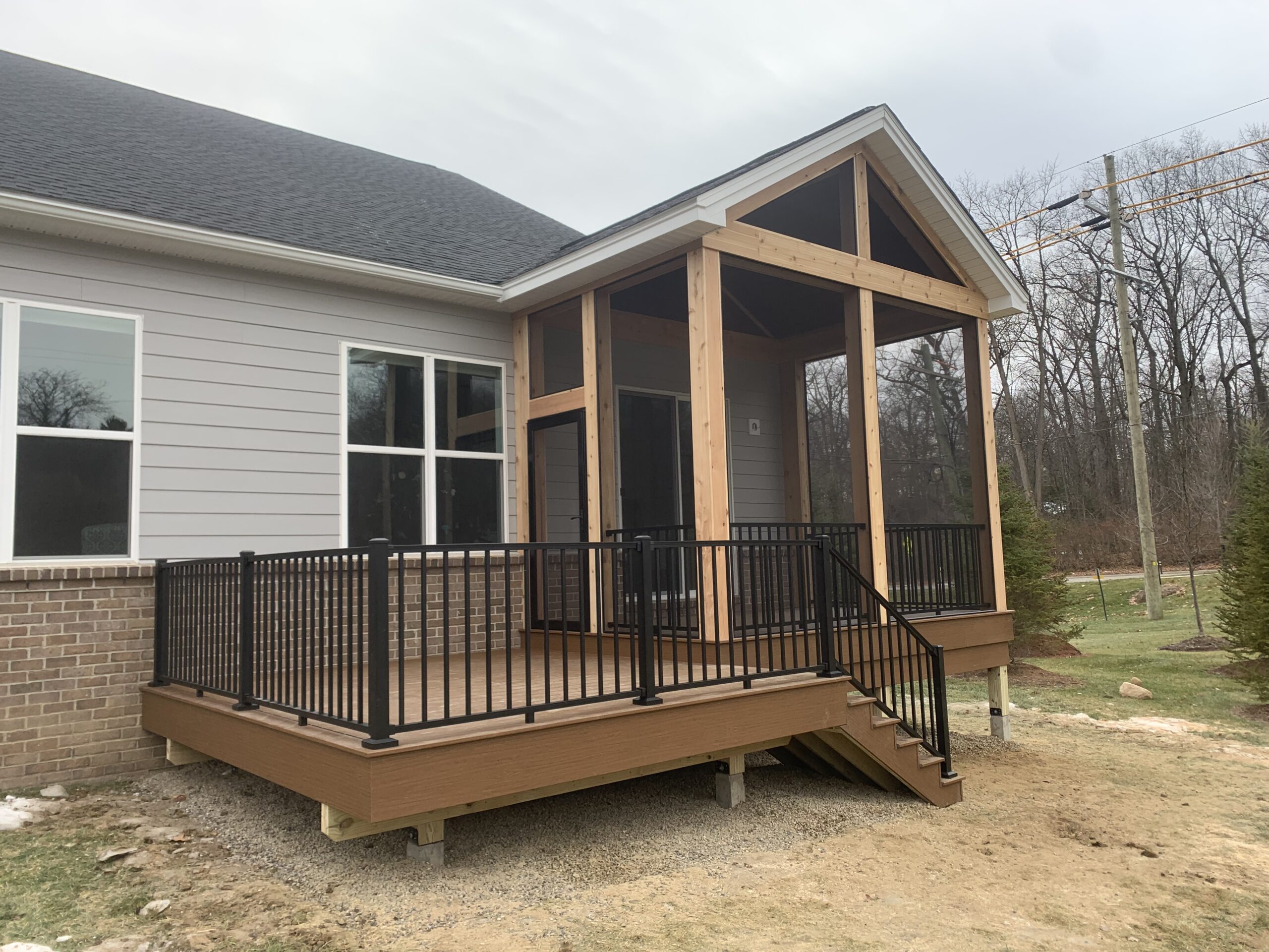 Ann Arbor Screened Porch Deck Rail Trex deck and screened porch builder in Ann Arbor MI with black railing and stairs