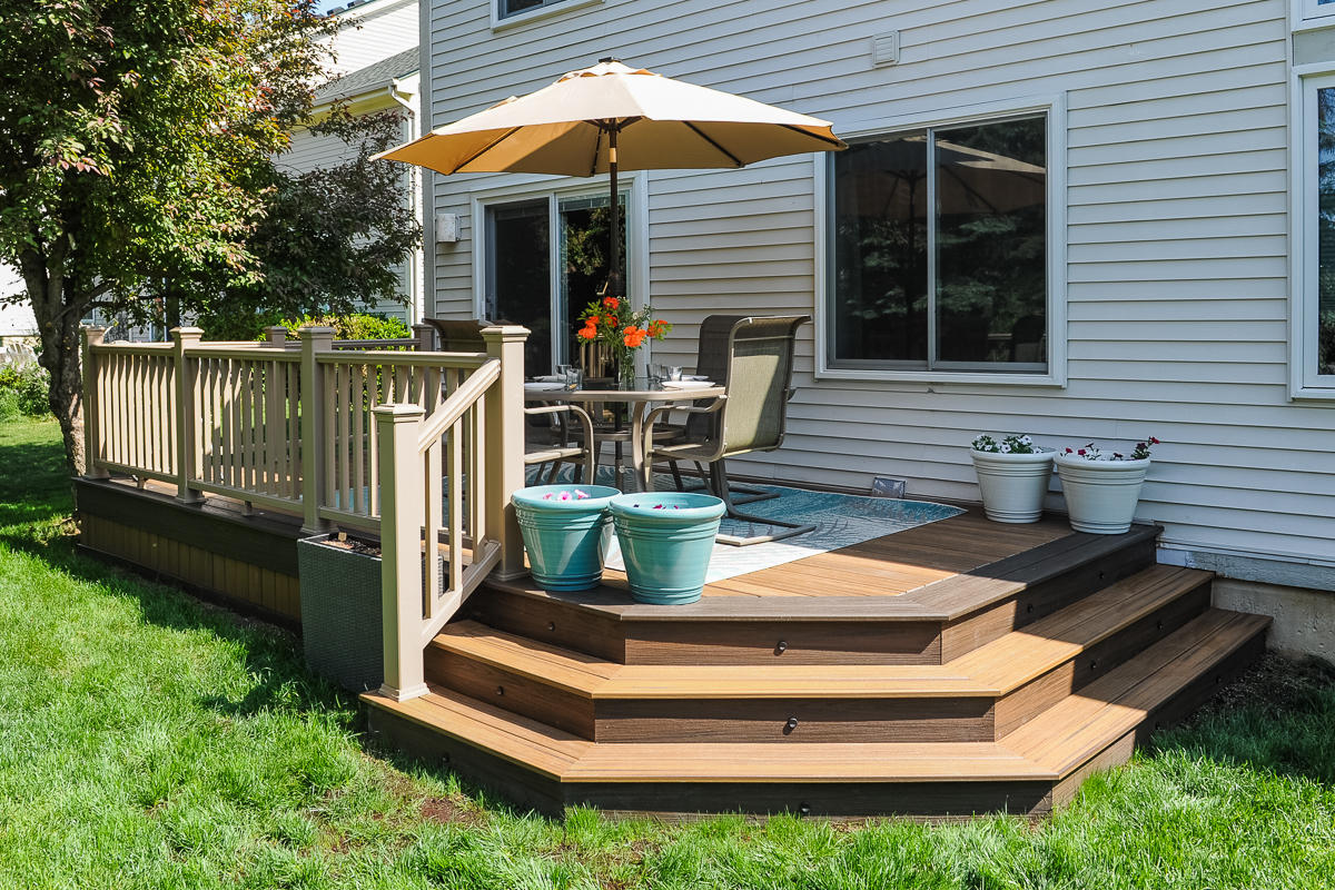 Low composite deck with multi-level stairs and tan railing in Scio Township MI